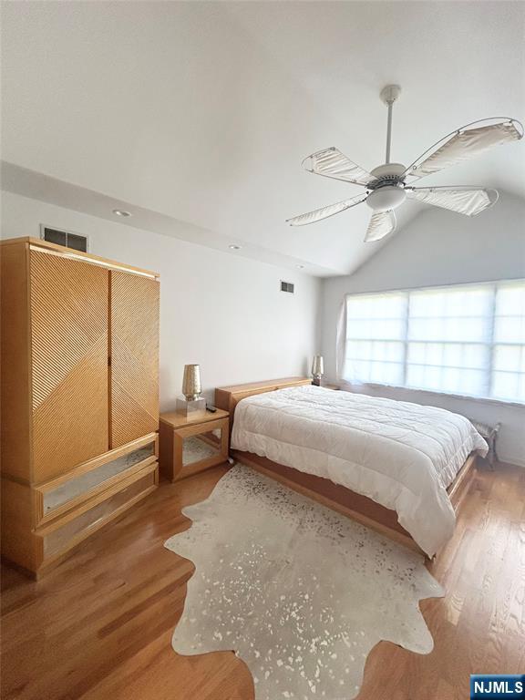 302 Grand Ridge Drive, Unit 302 Ridgefield, NJ 07657 - Photo 32 of 41 a bedroom with a bed and a chandelier