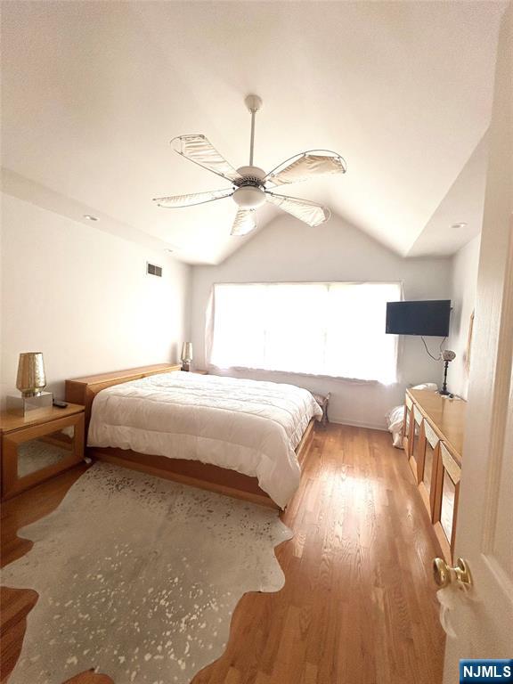 302 Grand Ridge Drive, Unit 302 Ridgefield, NJ 07657 - Photo 33 of 41 a bedroom with a bed and a chandelier