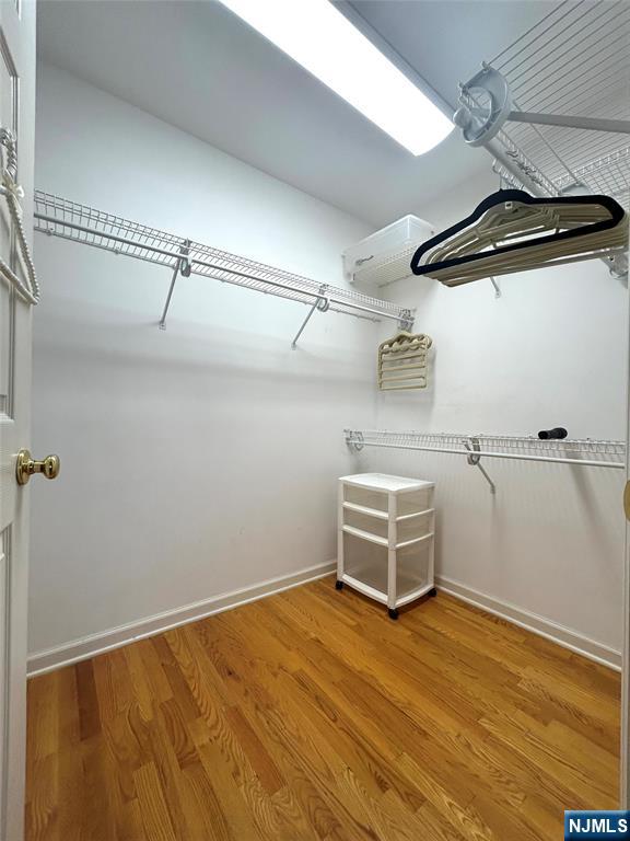 302 Grand Ridge Drive, Unit 302 Ridgefield, NJ 07657 - Photo 35 of 41 a room with a wooden floor and white walls