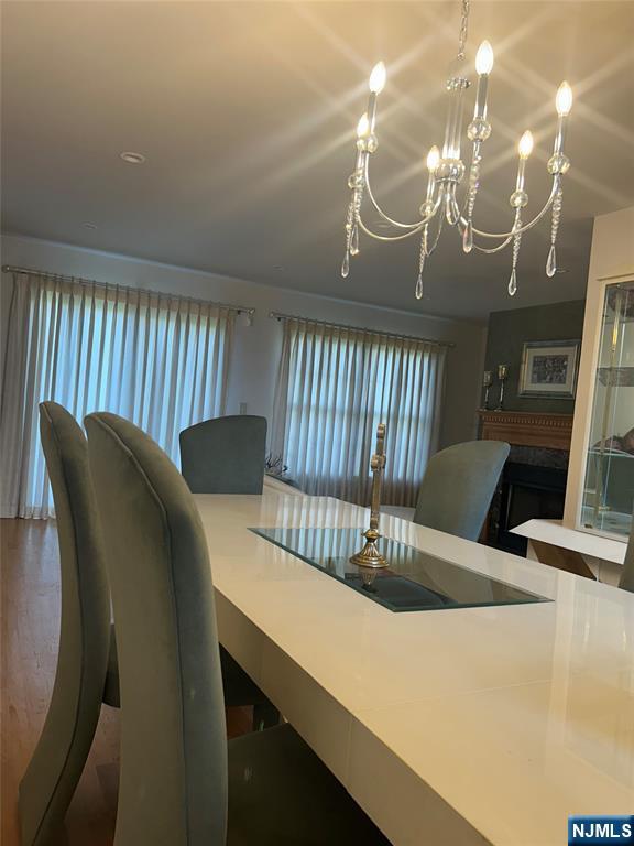 302 Grand Ridge Drive, Unit 302 Ridgefield, NJ 07657 - Photo 7 of 41 a view of a dining room with furniture and a chandelier