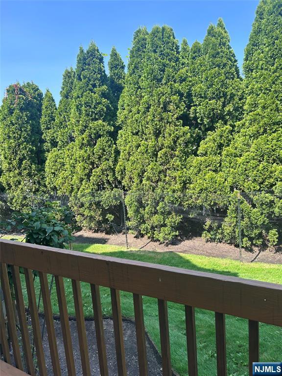 302 Grand Ridge Drive, Unit 302 Ridgefield, NJ 07657 - Photo 8 of 41 a view of a green yard with wooden fence