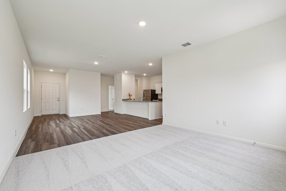 1516 Morris Loop San Marcos, TX 78666 - Photo 12 of 40 Unfurnished living room with recessed lighting and dark colored carpet