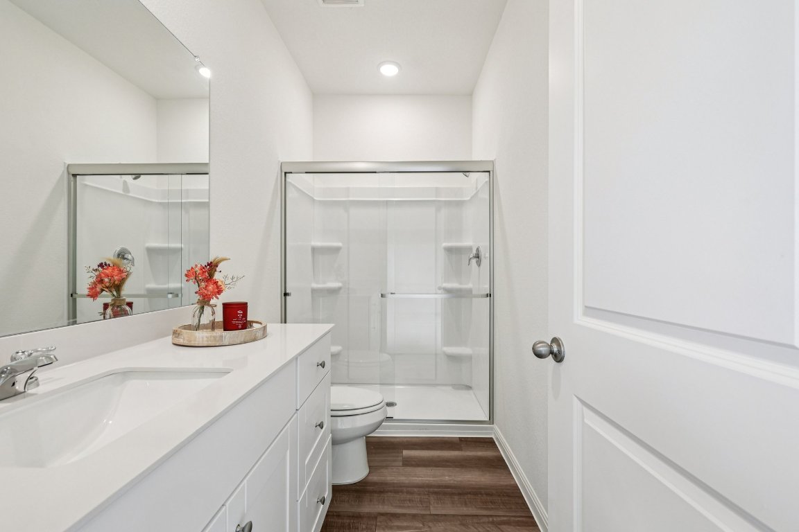 1516 Morris Loop San Marcos, TX 78666 - Photo 20 of 40 Full bathroom with a stall shower, dark wood finished floors, and vanity