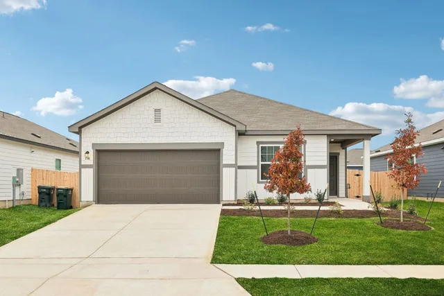 a view of a kitchen with kitchen island stainless steel appliances counter space and a sink