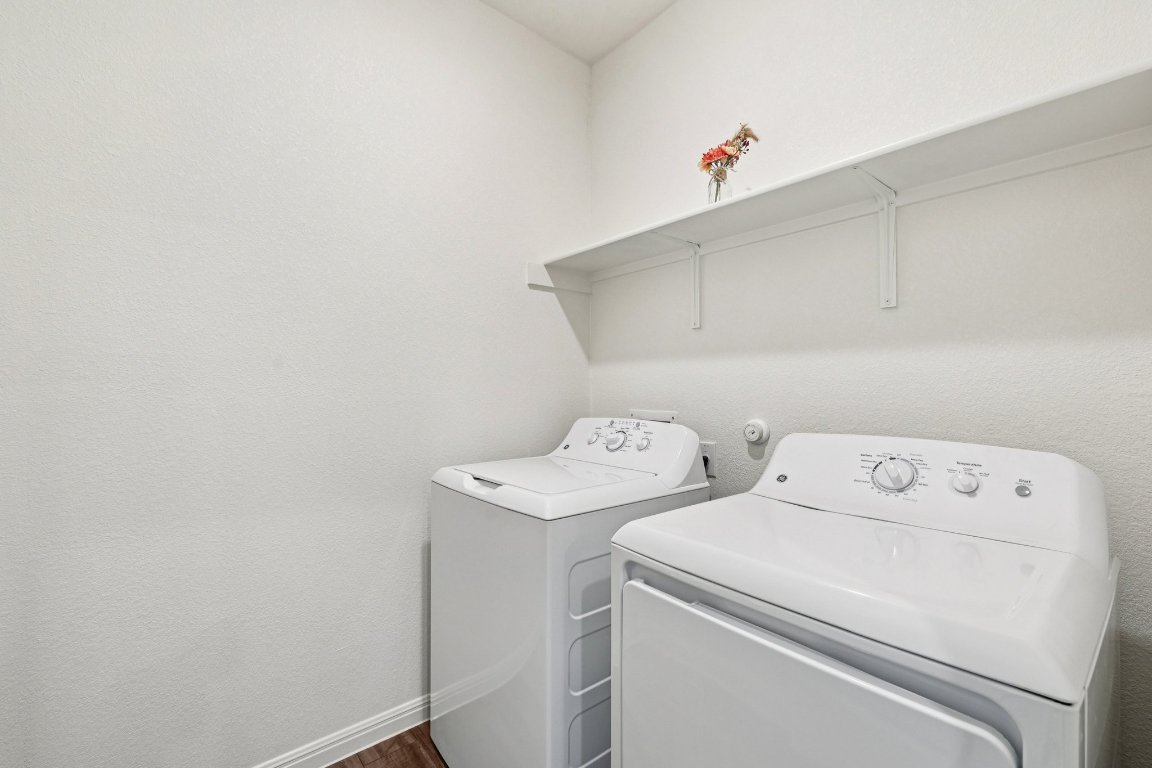 1516 Morris Loop San Marcos, TX 78666 - Photo 24 of 40 Laundry room featuring washing machine and dryer and a textured wall