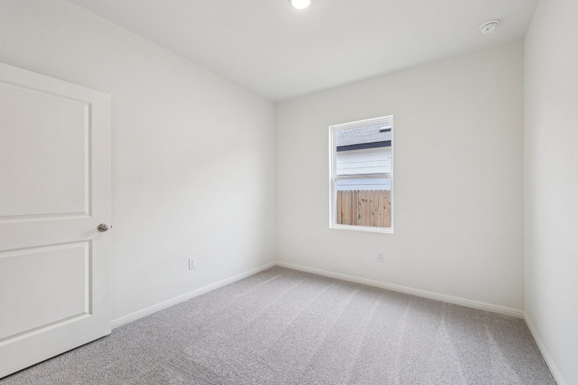 1516 Morris Loop San Marcos, TX 78666 - Photo 32 of 40 Carpeted empty room featuring baseboards