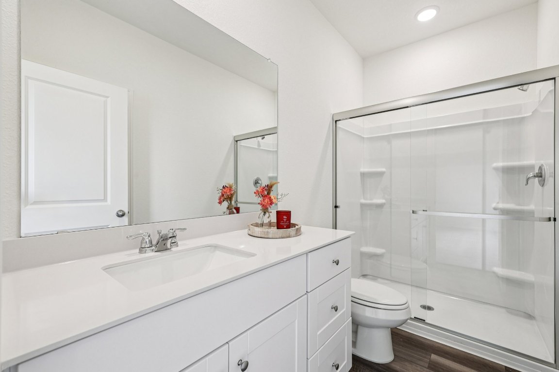 1516 Morris Loop San Marcos, TX 78666 - Photo 6 of 40 Bathroom with vanity, a stall shower, and dark wood finished floors