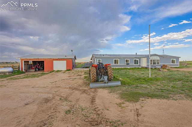 36015 Corona Road Yoder, CO 80864 - Photo 13 of 27 View of front of property featuring an outdoor structure and a garage