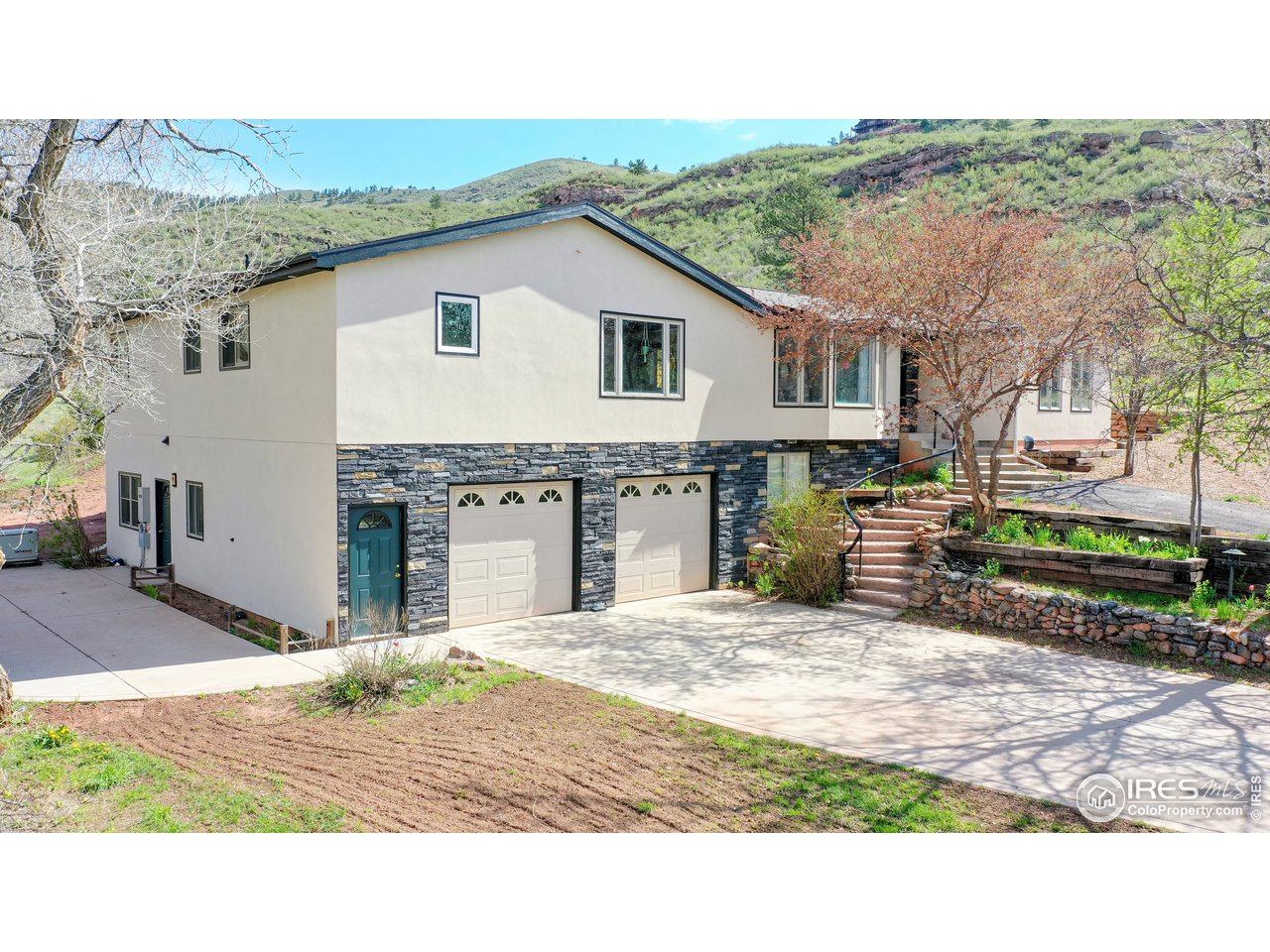 1200 Ponderosa Hill Road Lyons, CO 80540 - Photo 1 of 40 a view of a backyard with a garden and parking space