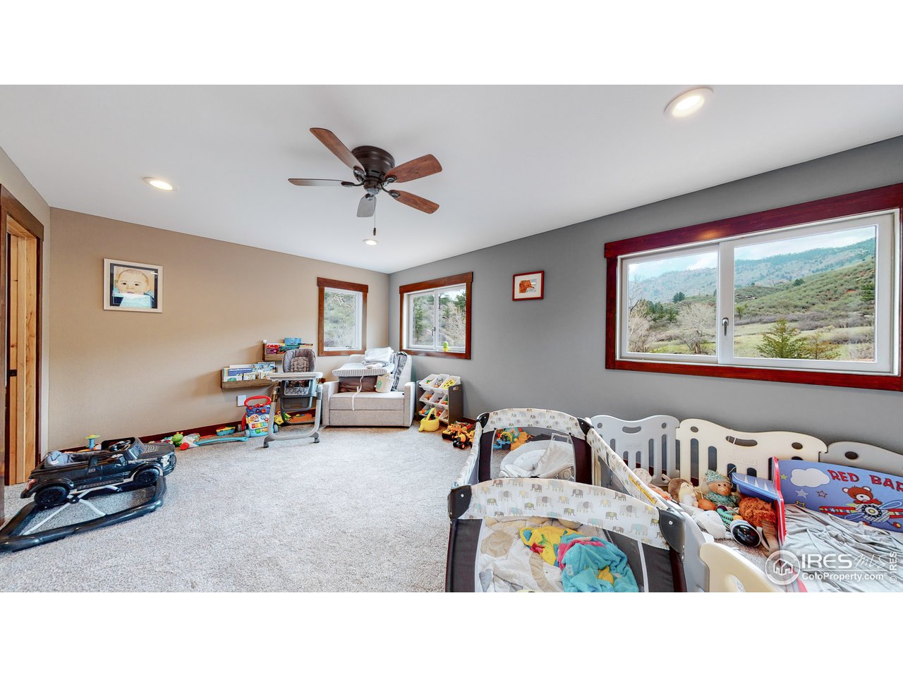1200 Ponderosa Hill Road Lyons, CO 80540 - Photo 15 of 40 a living room with furniture and a flat screen tv