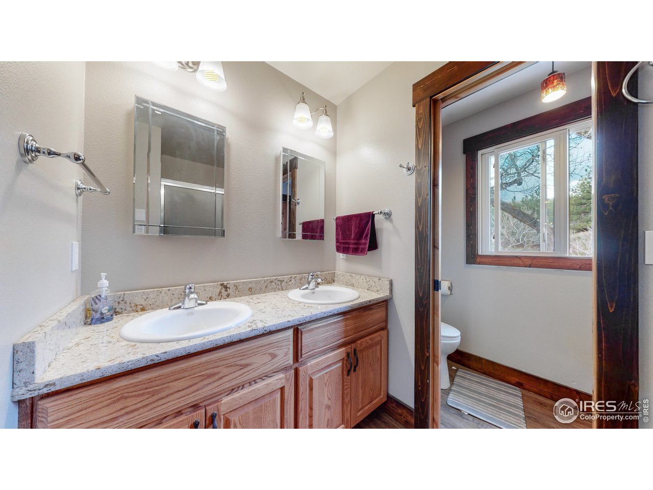 1200 Ponderosa Hill Road Lyons, CO 80540 - Photo 20 of 40 a bathroom with a sink vanity and mirror