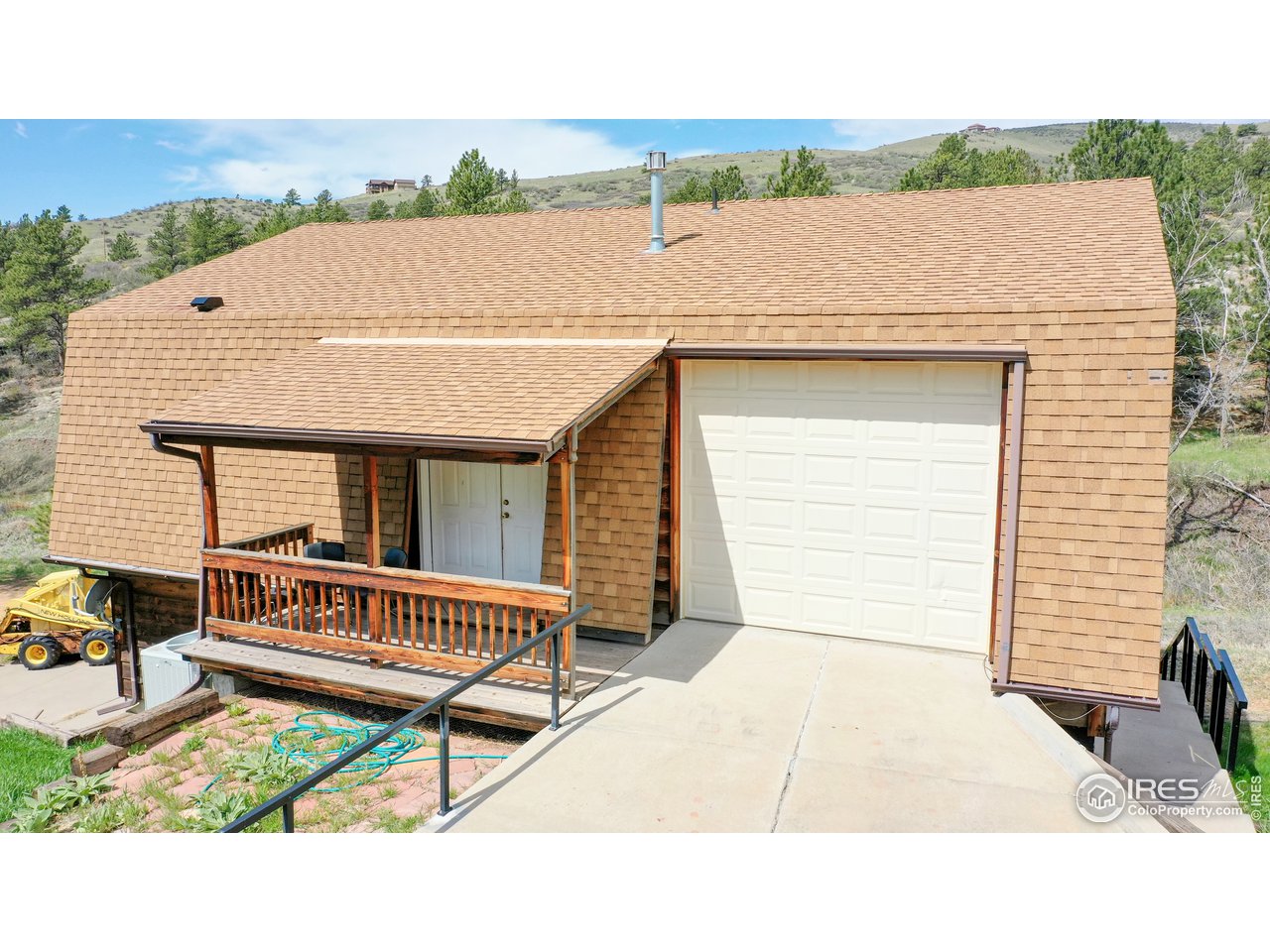 1200 Ponderosa Hill Road Lyons, CO 80540 - Photo 33 of 40 a white house with a table and chairs