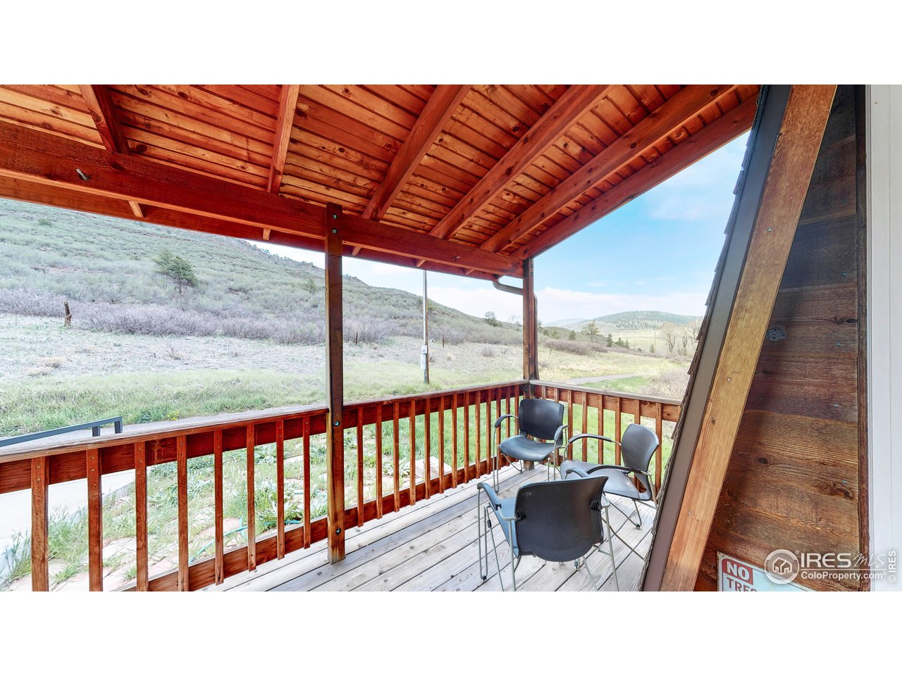 1200 Ponderosa Hill Road Lyons, CO 80540 - Photo 34 of 40 a balcony with furniture and umbrella