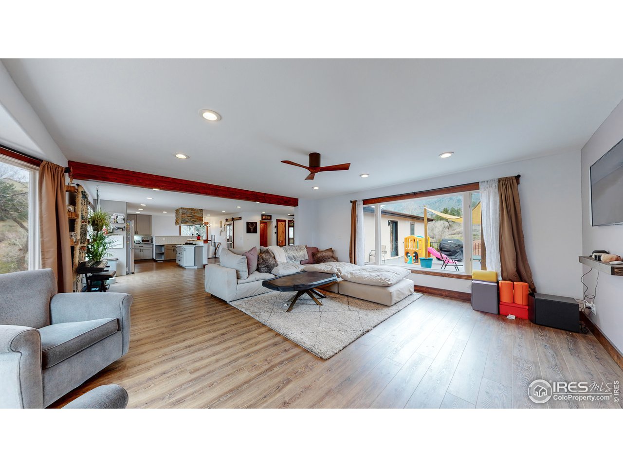 1200 Ponderosa Hill Road Lyons, CO 80540 - Photo 5 of 40 a living room with furniture and a wooden floor
