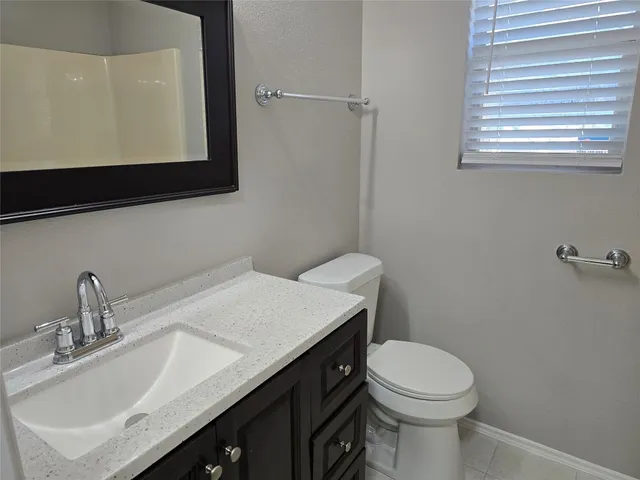 a bathroom with a sink a toilet and mirror