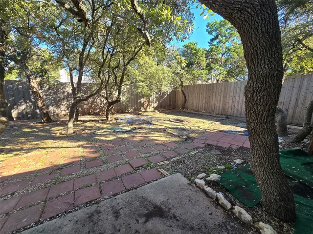 a view of yard with tree in the background