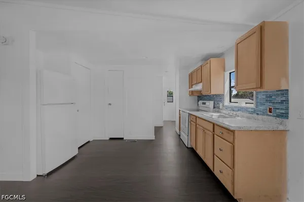 a kitchen with sink a stove and cabinets