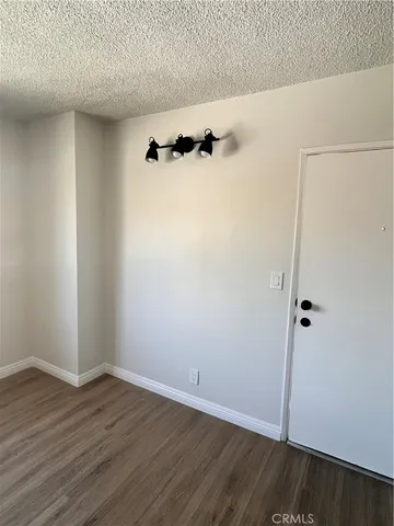 an empty room with wooden floor