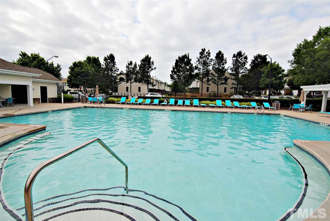 8220 Saltwood Place Raleigh, NC 27617 - Photo 14 of 15 a view of a swimming pool with a lawn chairs and a lake view