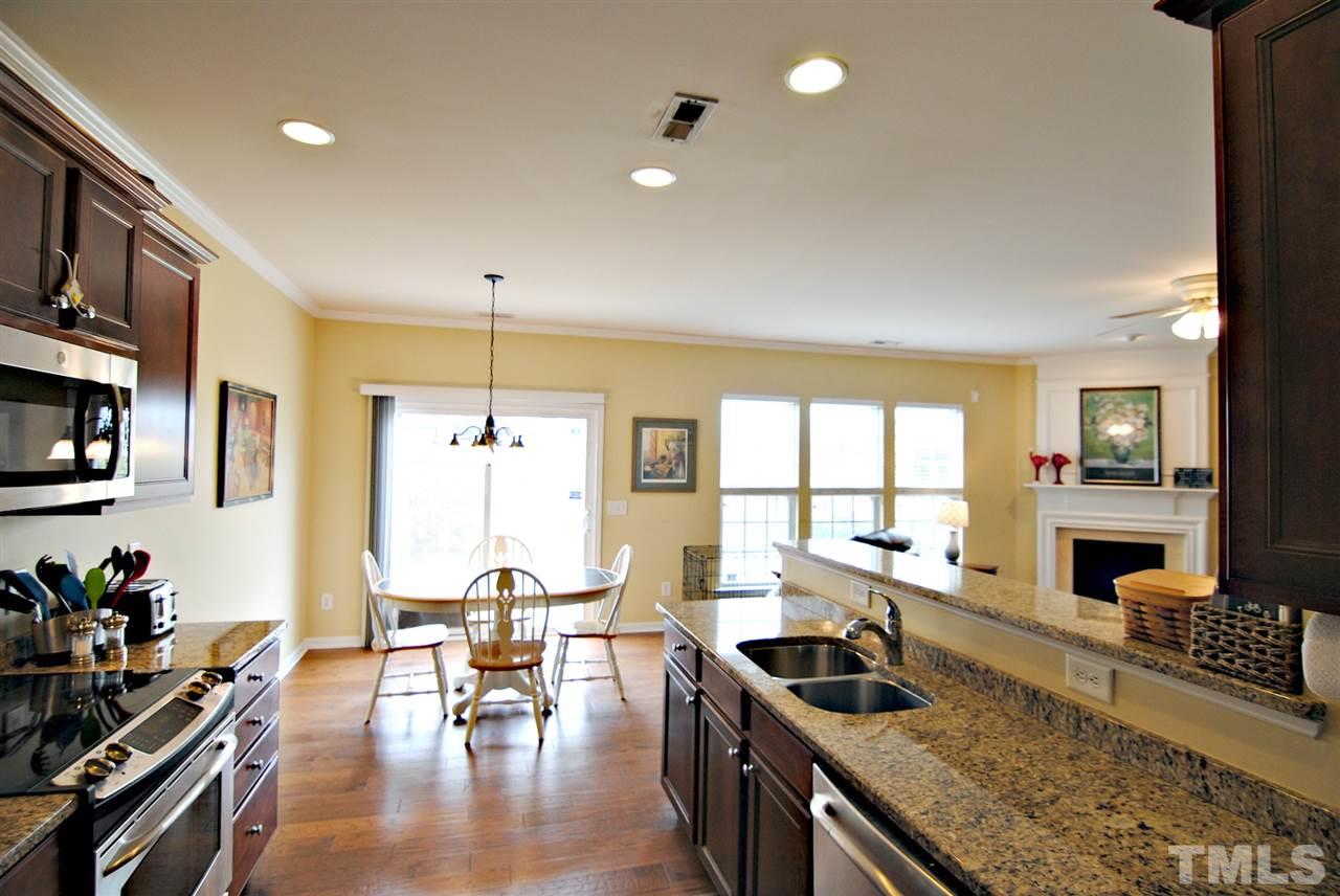 8220 Saltwood Place Raleigh, NC 27617 - Photo 5 of 15 a kitchen with counter top space a sink and appliances
