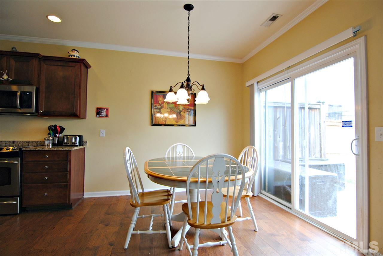 8220 Saltwood Place Raleigh, NC 27617 - Photo 7 of 15 a view of a dining room with furniture window and wooden floor