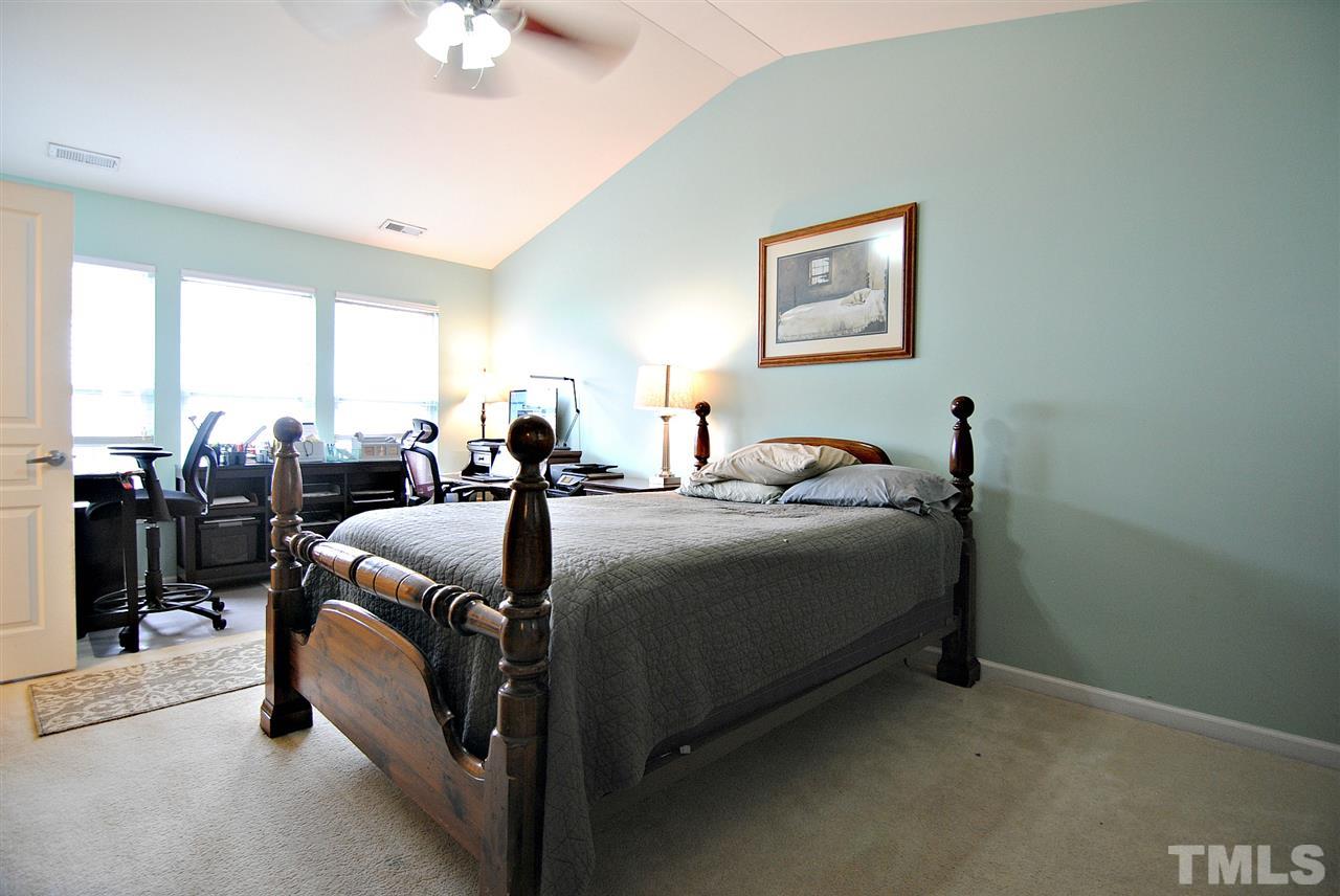 8220 Saltwood Place Raleigh, NC 27617 - Photo 8 of 15 a bed room with a bed and a lamp