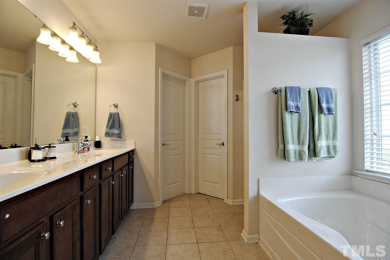 8220 Saltwood Place Raleigh, NC 27617 - Photo 9 of 15 a spacious bathroom with a bathtub sink and mirror