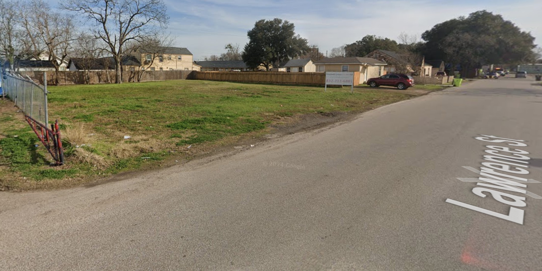 1009 Lawrence Street Rosenberg, TX 77471 - Photo 1 of 3 a front view of a house with a yard