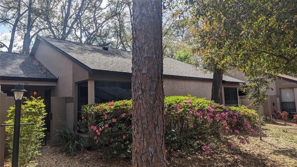 a view of a house with a flower garden