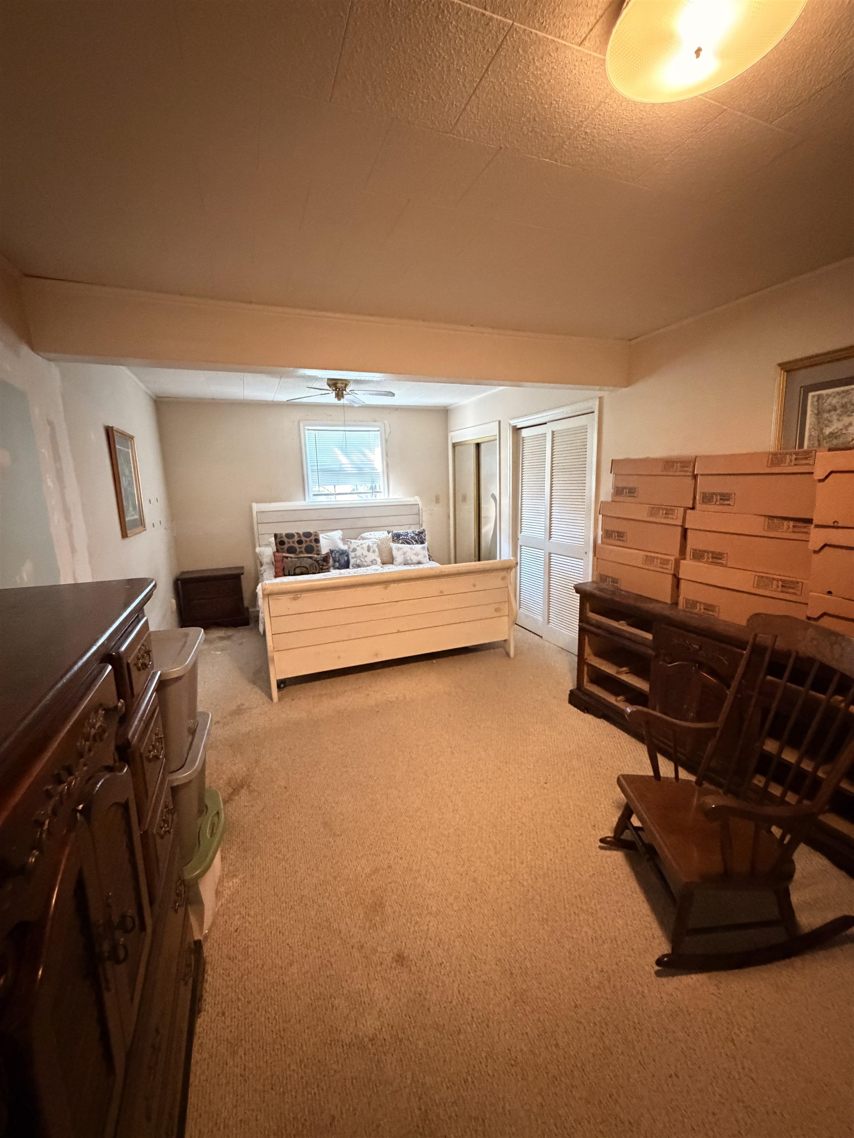 1111 Palmetto Street Georgetown, SC 29440 - Photo 17 of 36 Bedroom featuring a ceiling fan, dark colored carpet, and a textured ceiling