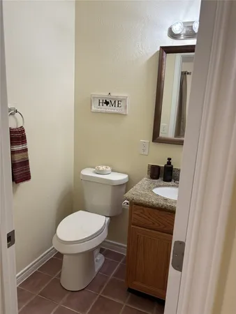 a white toilet sitting next to a bathroom sink