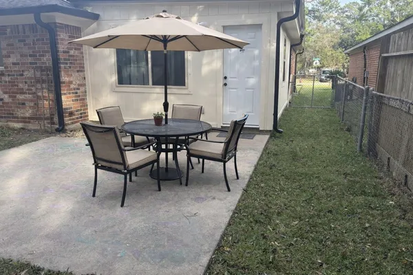 a patio with a table and chairs