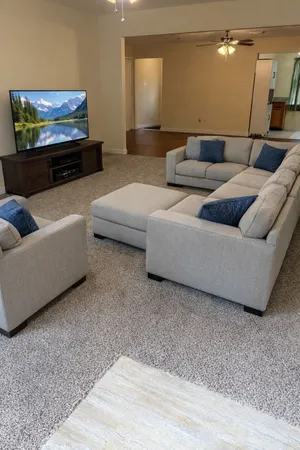 a living room with furniture and a flat screen tv