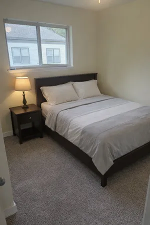 a bedroom with a bed and window