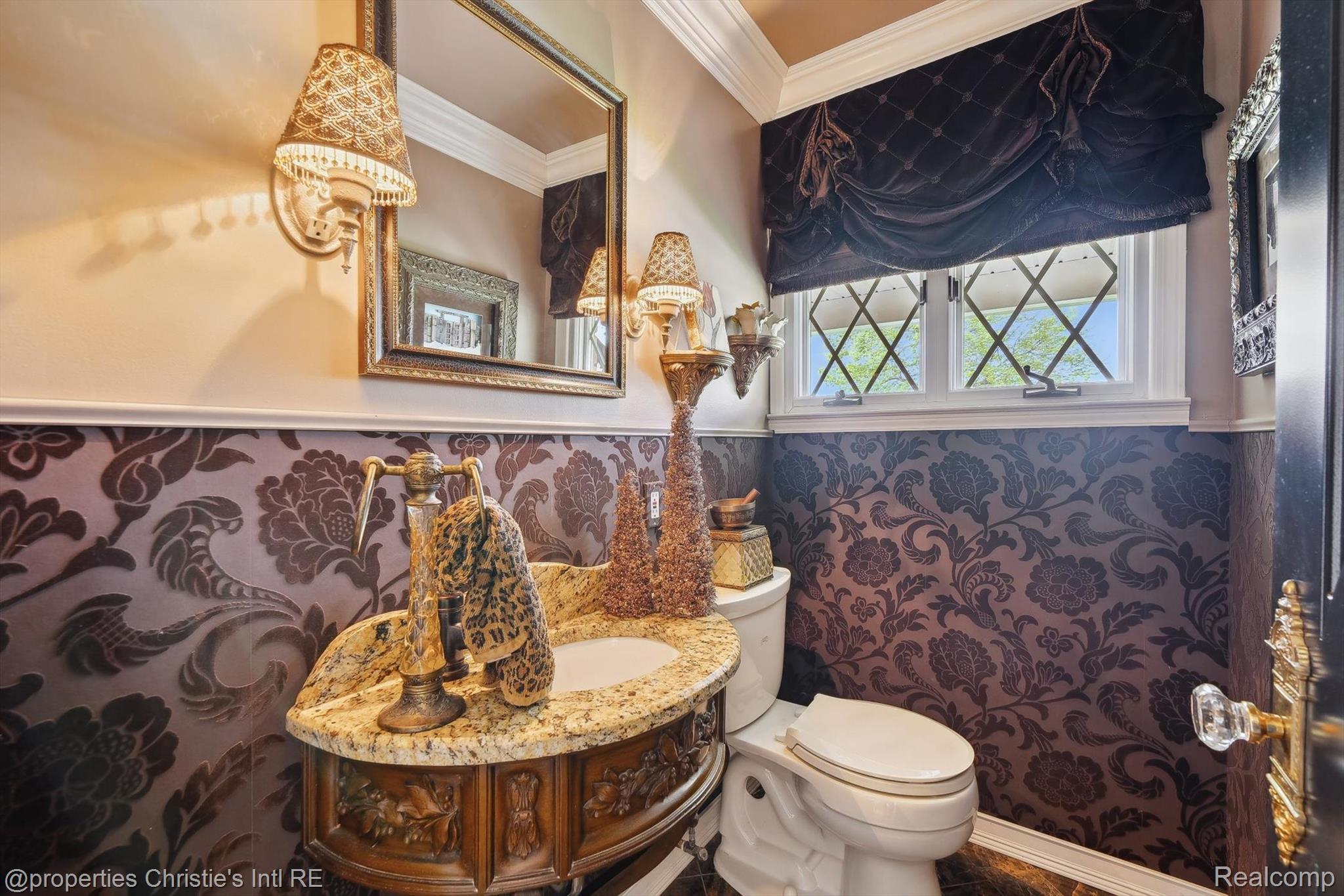 511 South Gulley Road Dearborn, MI 48124 - Photo 28 of 43 Ornate vanity with a stone countertop, decorative wall sconces, framed mirror, and a window with diamond-patterned grilles