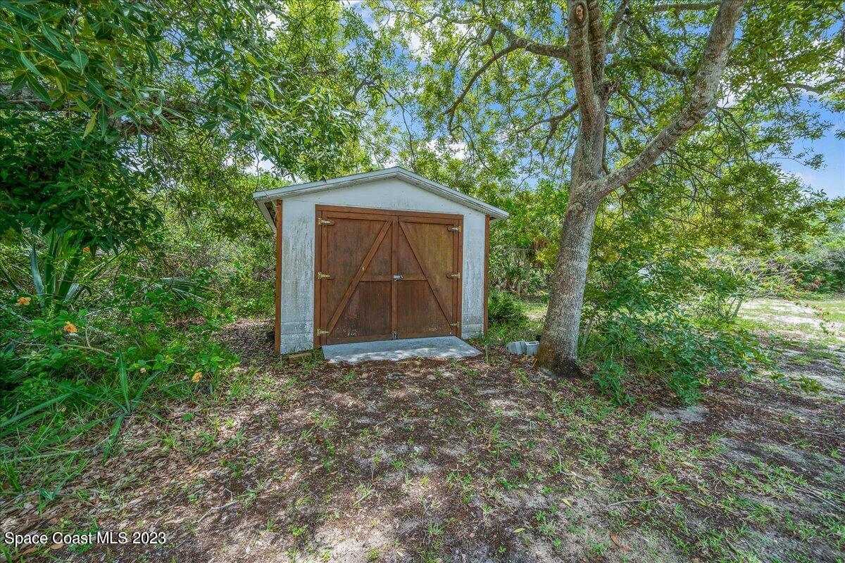 4885 Sand Point Road Grant, FL 32949 - Photo 13 of 36 a house with trees in front of it