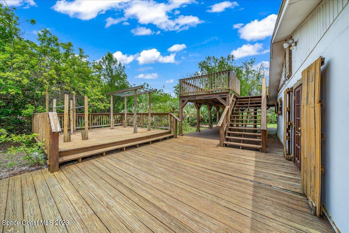 4885 Sand Point Road Grant, FL 32949 - Photo 14 of 36 a view of outdoor space with deck and patio