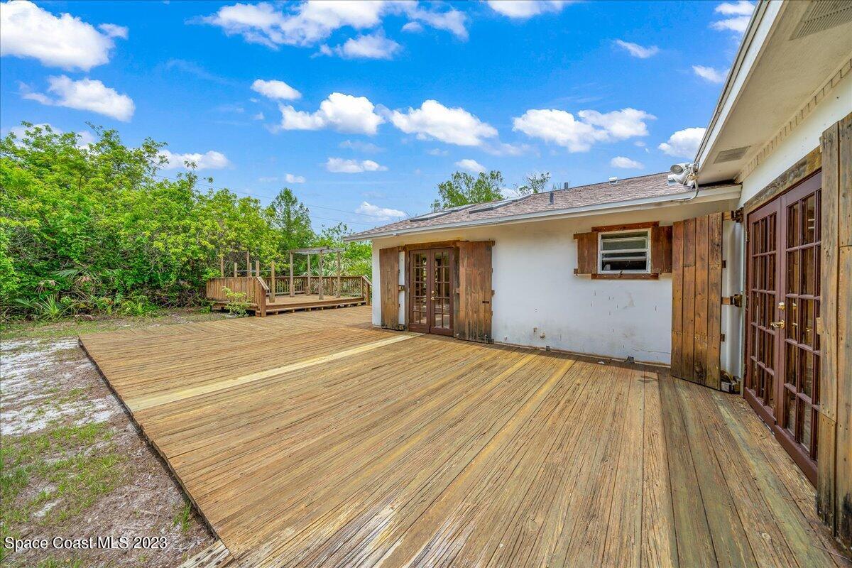 4885 Sand Point Road Grant, FL 32949 - Photo 15 of 36 a view of backyard of house with wooden floor