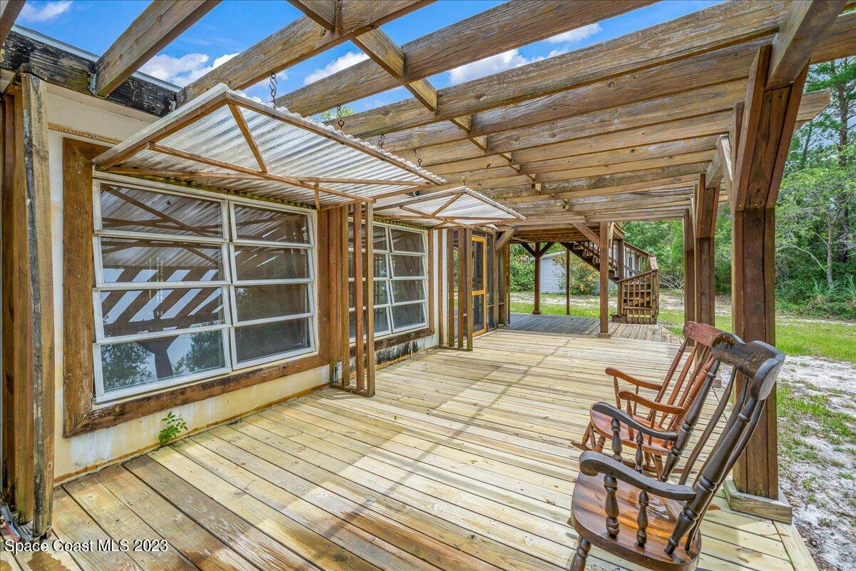 4885 Sand Point Road Grant, FL 32949 - Photo 16 of 36 a view of a room with wooden floor and windows