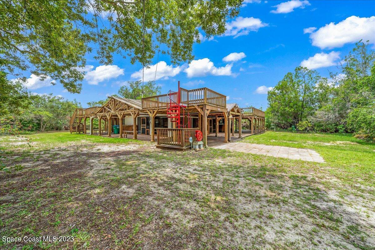 4885 Sand Point Road Grant, FL 32949 - Photo 2 of 36 a view of a house with a big yard