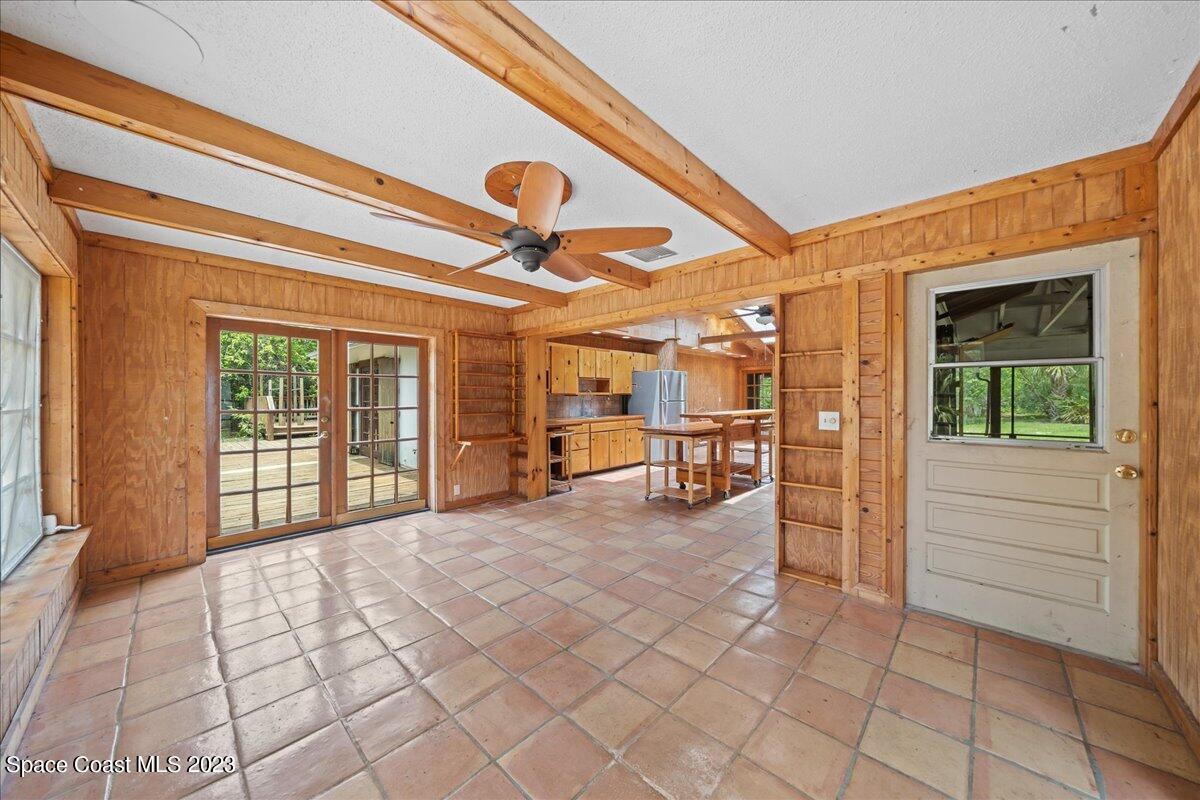 4885 Sand Point Road Grant, FL 32949 - Photo 28 of 36 a spacious bedroom with a bed and a cabinets