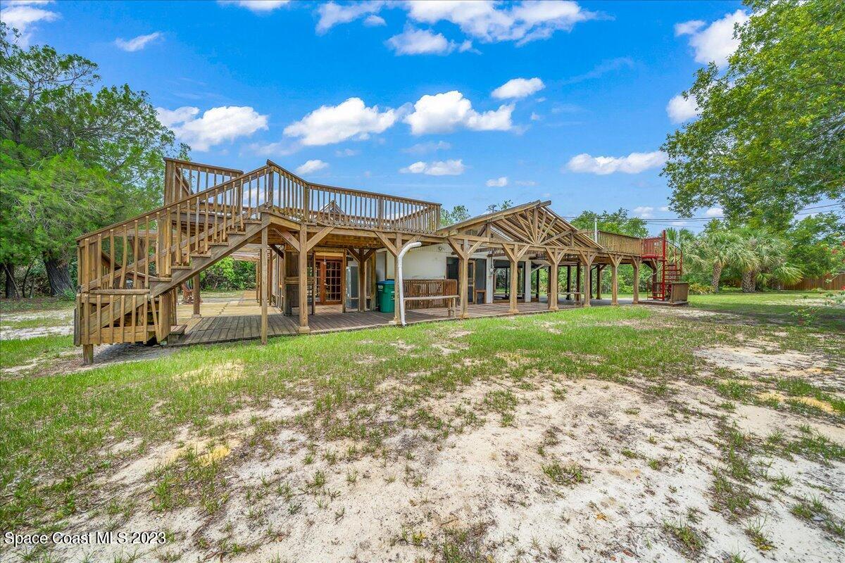 4885 Sand Point Road Grant, FL 32949 - Photo 8 of 36 a view of a house with a yard