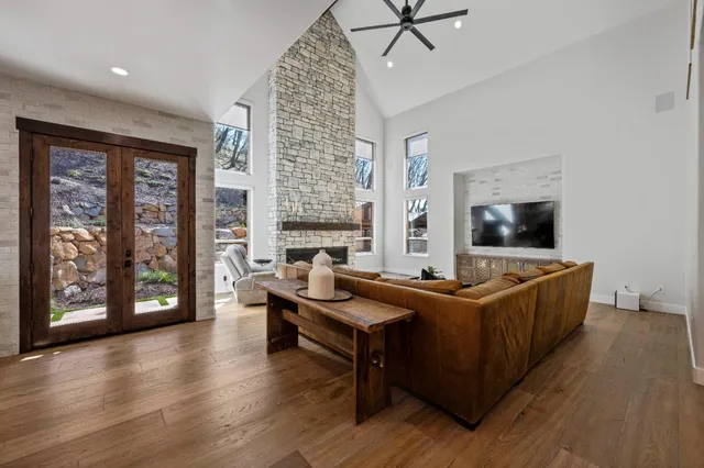 a bathroom with a sink and a large mirror next to a window