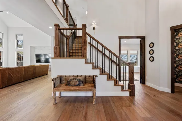 a large room with lots of furniture and a wooden floor