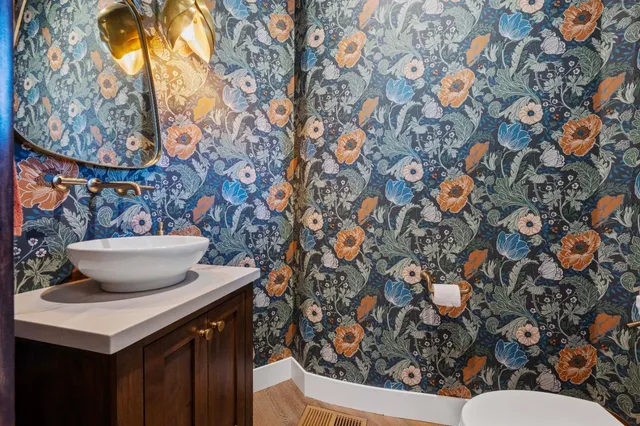 a view of a patio with a table and chairs under an umbrella