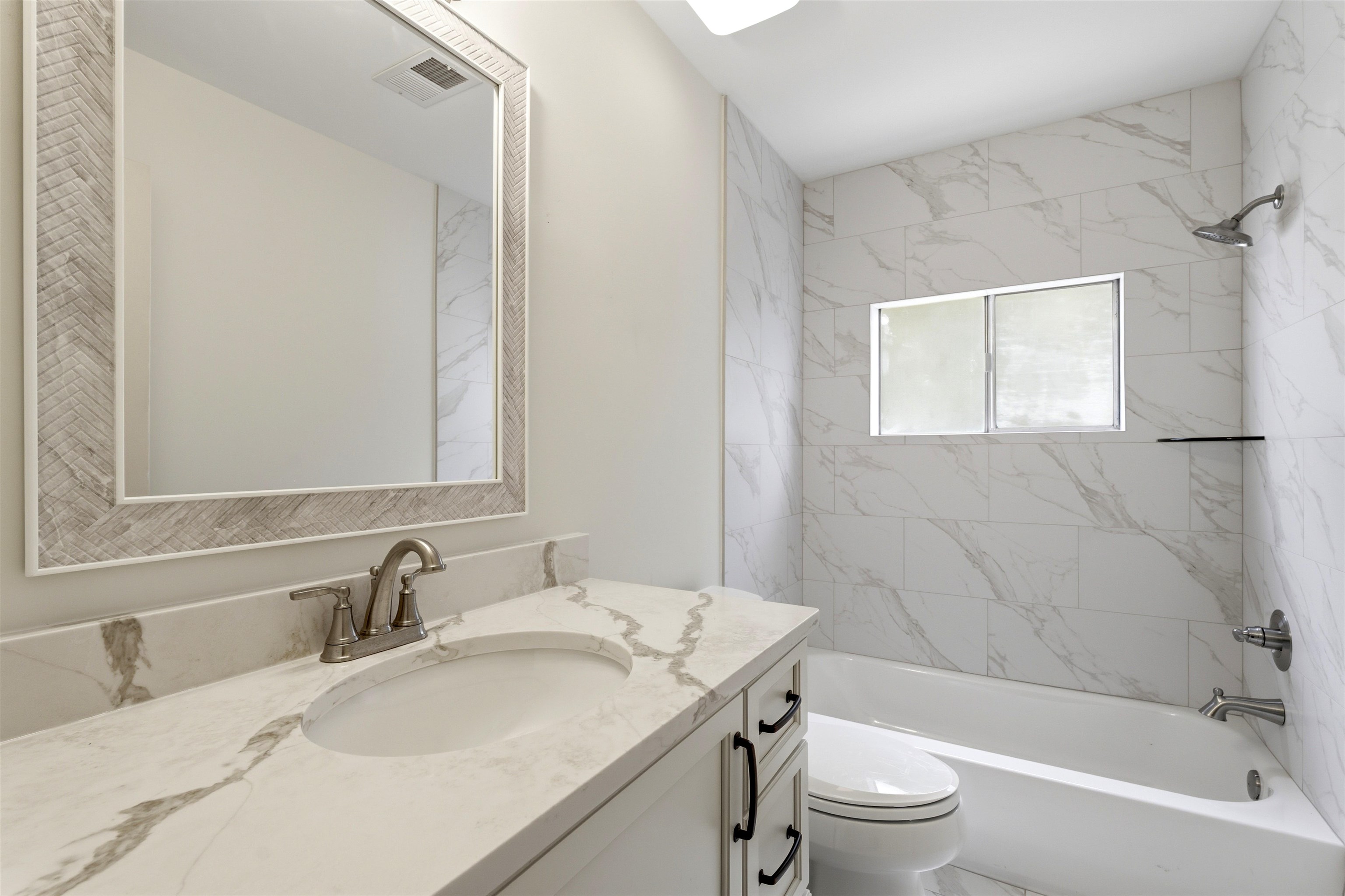 1984 Allenby Road Germantown, TN 38139 - Photo 27 of 37 White vanity with a stone-finish countertop, under-mount sink, and brushed nickel faucet