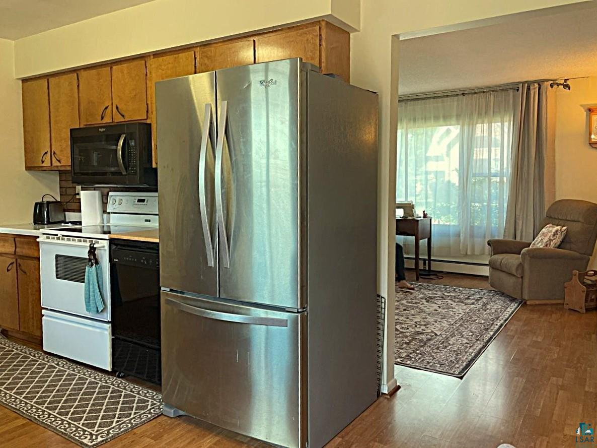 42 Locust Drive Babbitt, MN 55706 - Photo 12 of 50 Kitchen feature stainless steel refrigerator, microwave/fan venting, electric stove, dishwasher & trash compactor.