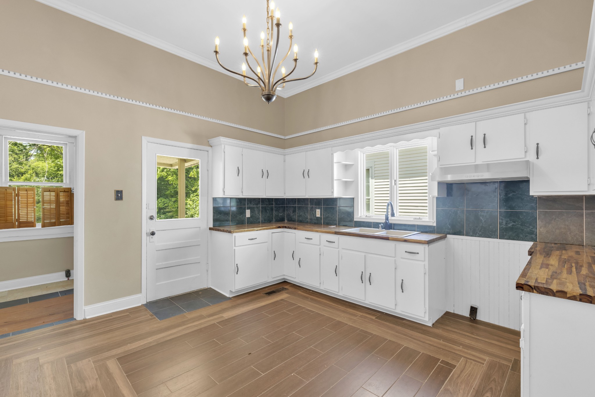 115 North Main Street Springfield, TN 37172 - Photo 19 of 24 a kitchen with granite countertop white cabinets and white appliances