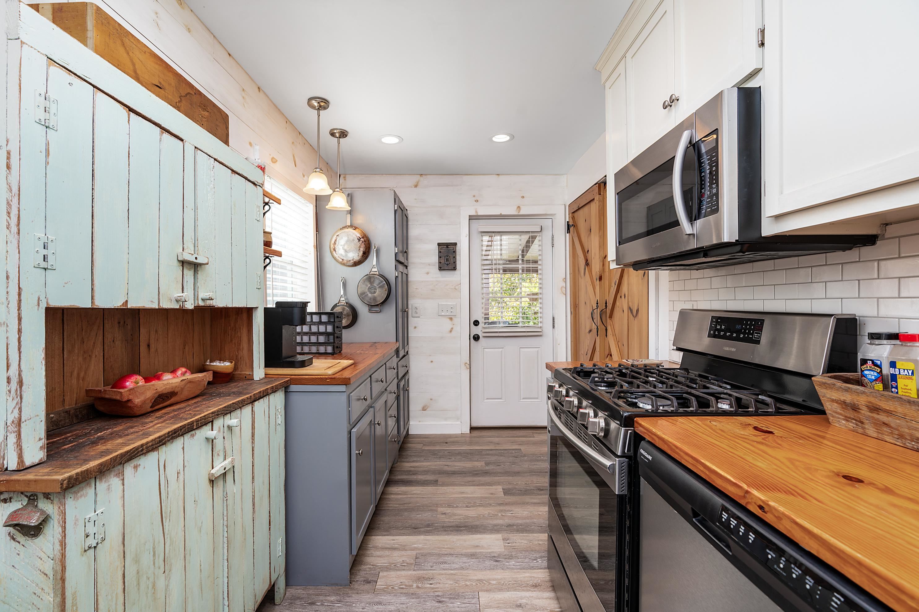 203 Jericho Road Fishersville, VA 22939 - Photo 6 of 13 a kitchen with stainless steel appliances granite countertop a stove a sink and a microwave
