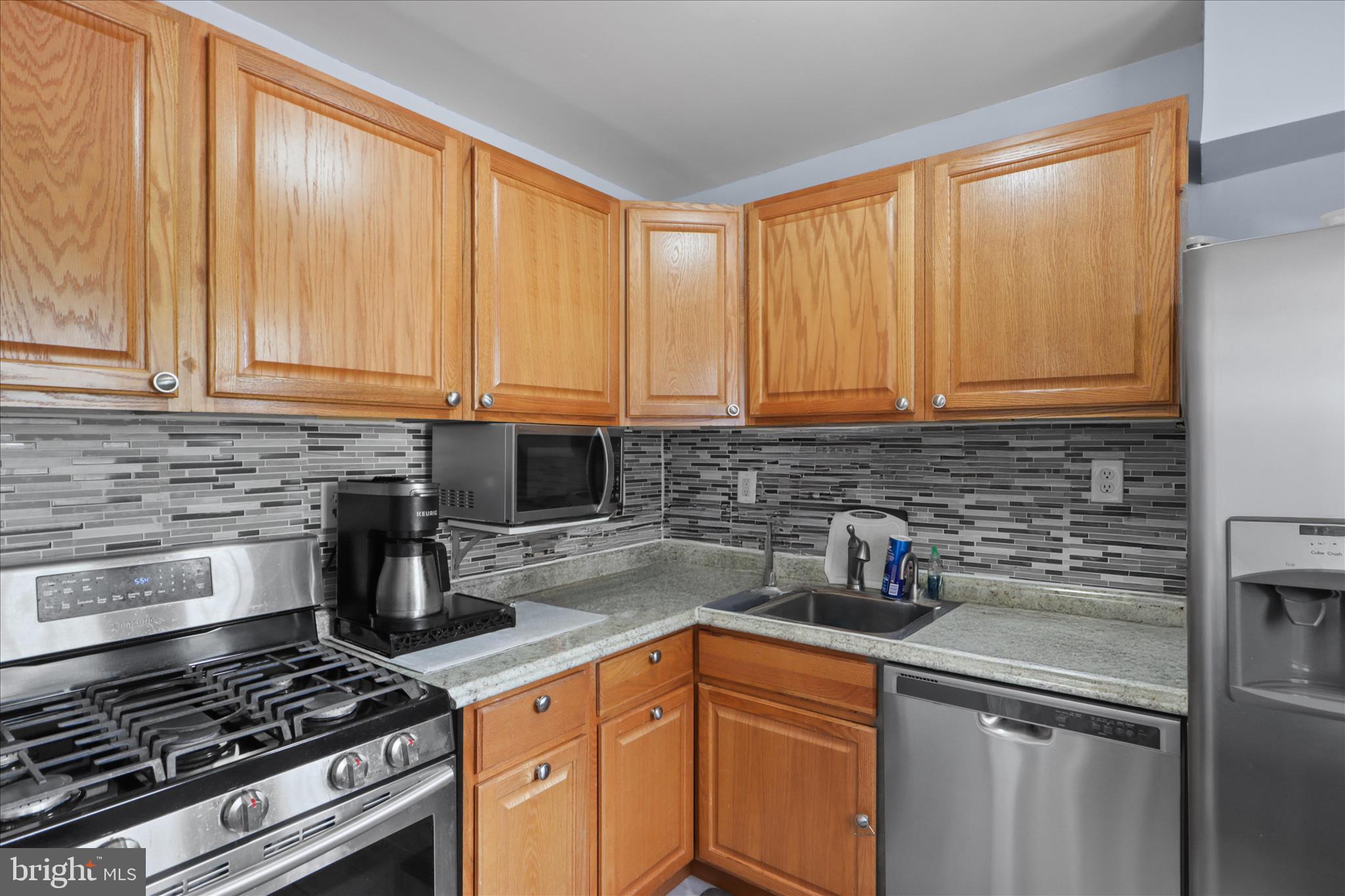 10602 Edgewood Avenue Silver Spring, MD 20901 - Photo 17 of 66 a kitchen with stainless steel appliances granite countertop a sink a stove and cabinets